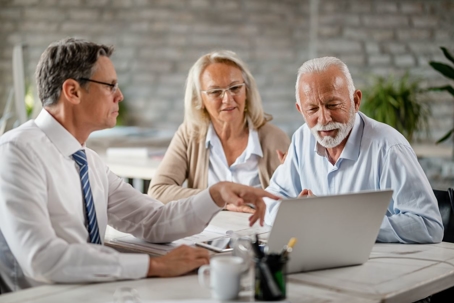 Elderly couple discussing estate plans with attorney