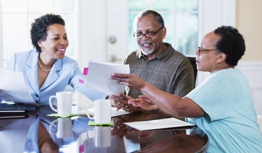 Elderly couple discussing their estate plans with attorney